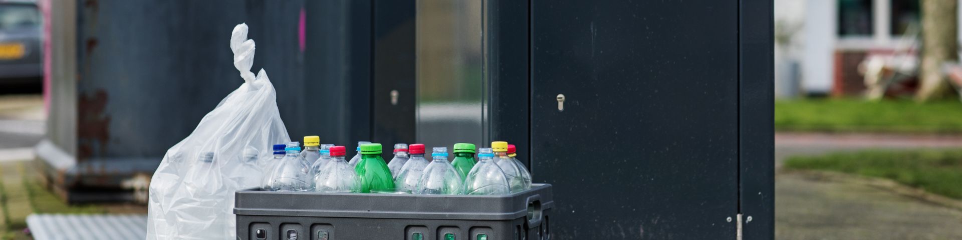 Plastic is outside next to the waste container