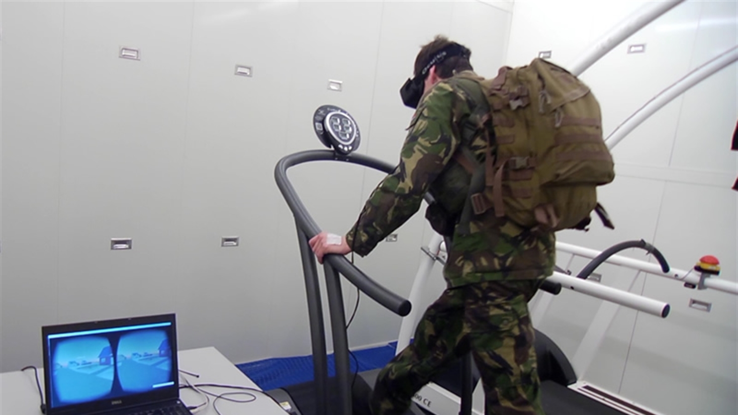Soldier runs on a treadmill wearing a VR headset for exercise and training.