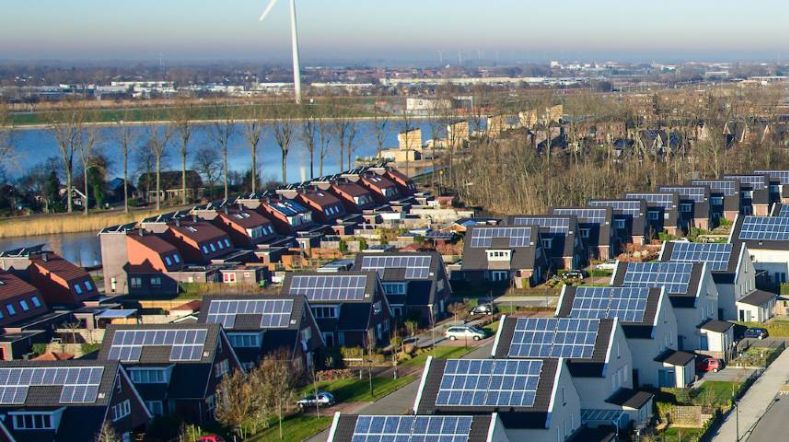 Overzicht woonwijk met zonnepanelen op alle daken van de huizen