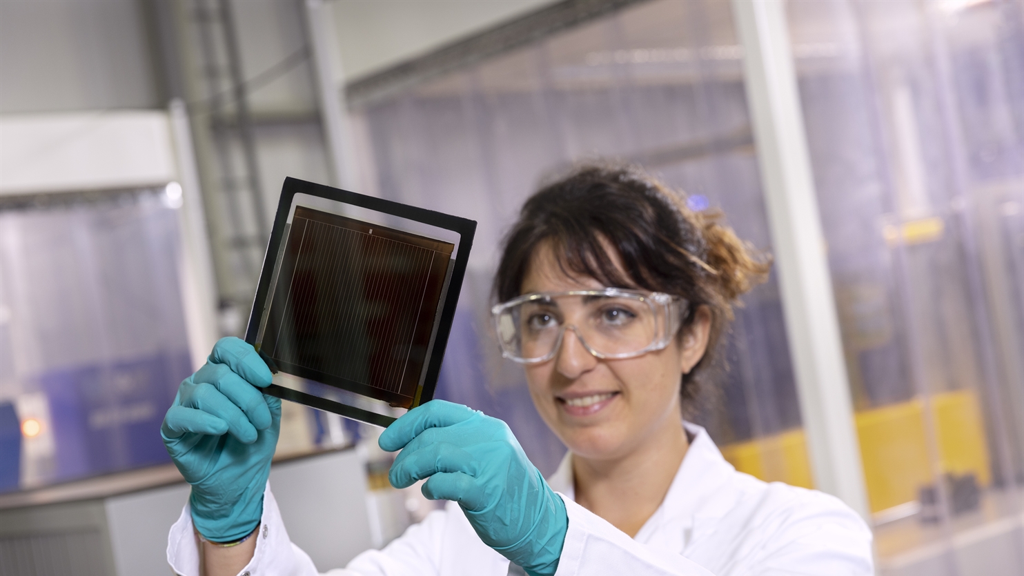 Scientist holding perovskite solar cell