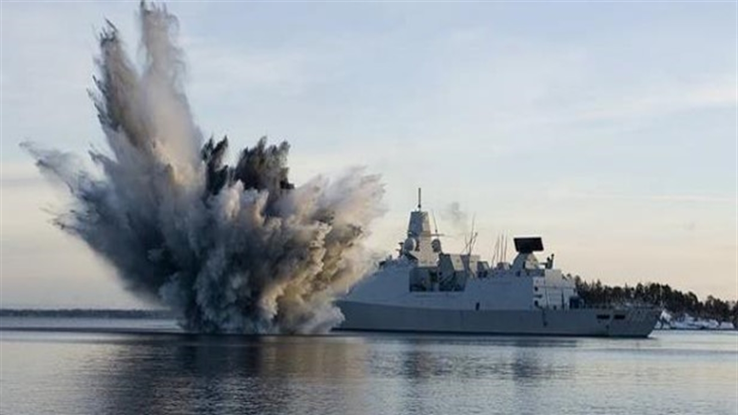 Nacel ship with explosion next to it in the sea