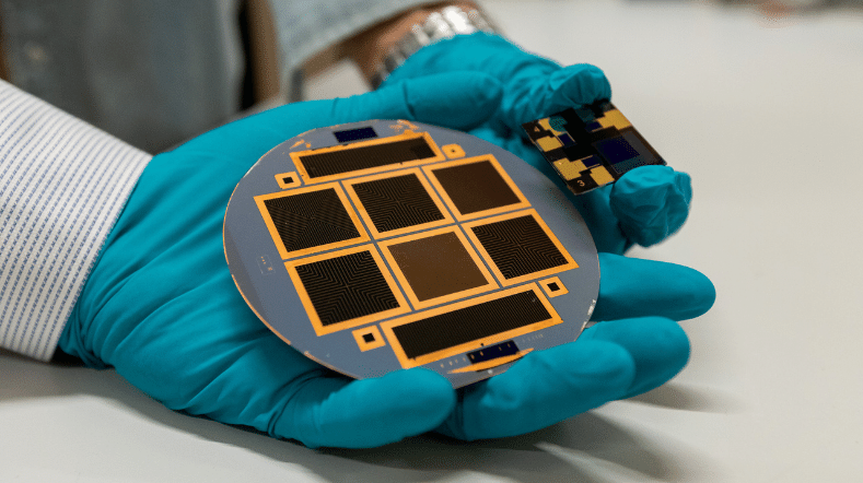 Silicon PV solar cell hold by a person