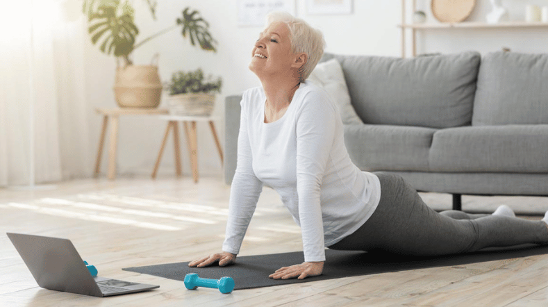 Woman stretching and doing yoga as a sport to prevent lifestyle related diseases